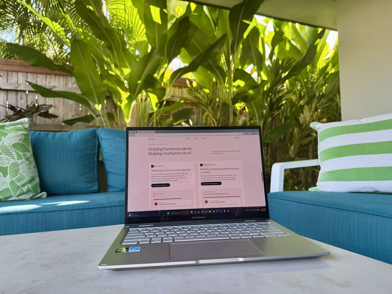 Mayventa website displayed on a laptop in a relaxed outdoor workspace with tropical greenery.